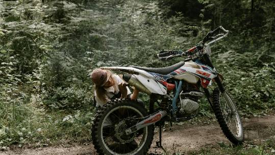 reliable repairs maintenance, thoughtful expression, confidently assessing, photorealistic, well-stocked shelves with neatly arranged tools, highly detailed, dust particles illuminated in the air, functional aesthetic, neutral colors, natural window lighting, shot with a 24mm lens.