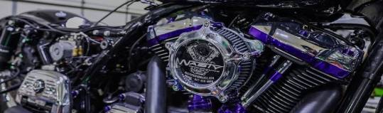 advanced repairs equipment, polished sheen, efficiently operating, photorealistic, industrial setting with overhead cranes, highly detailed, hoses and cables intersecting dynamically, precise detailing, silver and black tones, spotlighting for emphasis, shot with a 100mm lens.