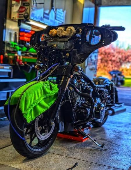 innovative audio setup, focused, calibrating sound system, photorealistic, state-of-the-art studio with soundproofing panels, highly detailed, equipment with LED displays, high resolution, cool tones, soft ambient glow, shot with an ultra-wide-angle lens.