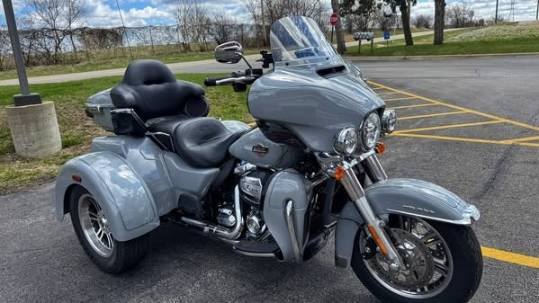 motorcycle mechanic in action, determined expression, welding frame, photorealistic, bustling shop atmosphere with acetylene torches and work lights, highly detailed, scattering sparks, fisheye lens, deep metallic colors, intense spotlighting