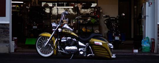 dynamic performance tuning, intense concentration, fine-tuning parts, photorealistic, high-tech automotive bay with shining cars, highly detailed, digital readouts, ultra HD, vibrant green, natural sunlight, shot with a 24mm lens